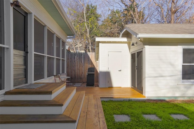 wooden terrace featuring grilling area and fence