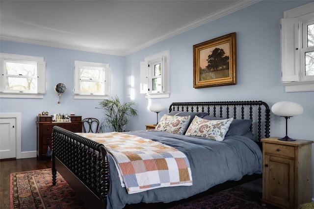 bedroom featuring ornamental molding, dark wood-type flooring, and baseboards