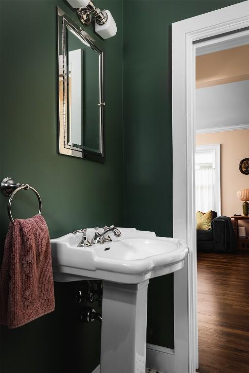 bathroom featuring crown molding and wood finished floors