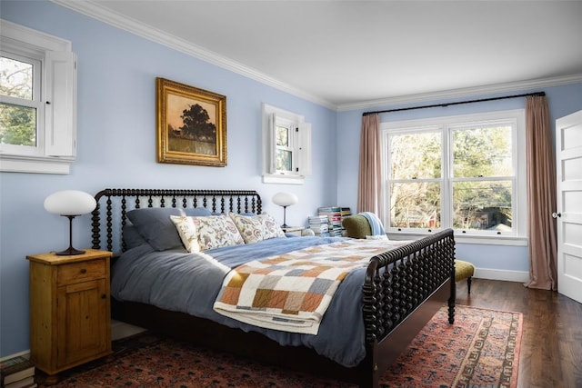 bedroom with baseboards, dark wood-type flooring, and crown molding