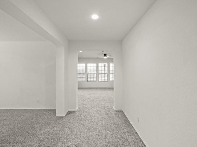 corridor featuring recessed lighting, carpet, and baseboards