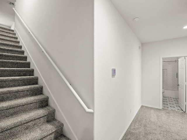 stairway with carpet flooring and baseboards