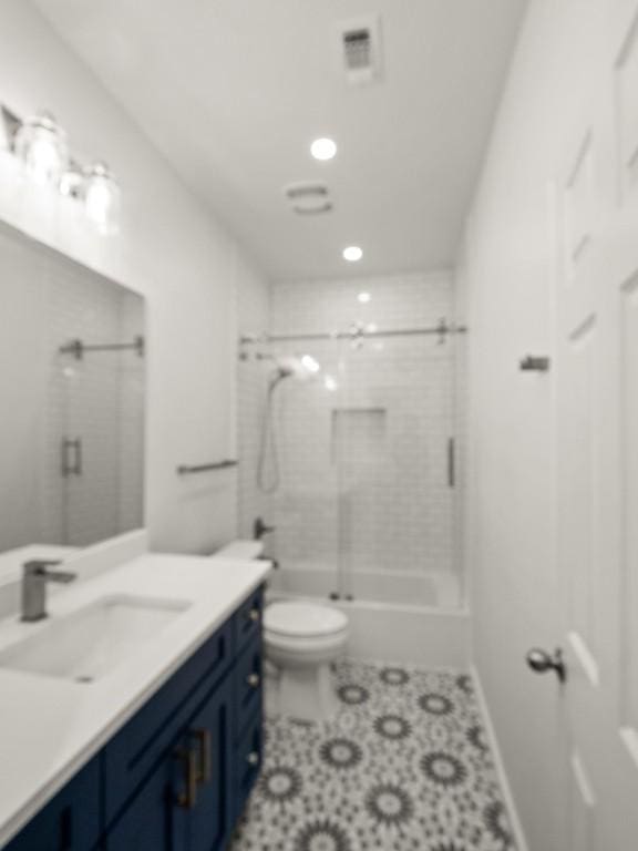 full bathroom with visible vents, vanity, walk in shower, and toilet