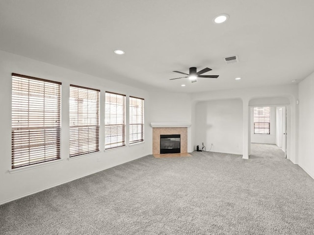 unfurnished living room with recessed lighting, visible vents, and a tiled fireplace