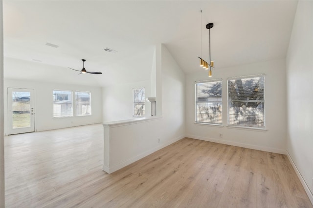 unfurnished dining area featuring light wood-type flooring, visible vents, baseboards, lofted ceiling, and ceiling fan