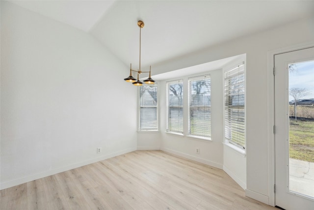 unfurnished dining area with light wood-type flooring, a wealth of natural light, lofted ceiling, and baseboards