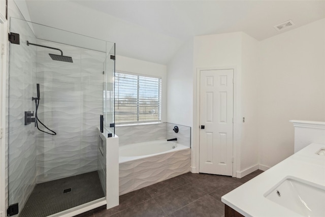 bathroom featuring a garden tub, double vanity, visible vents, tile patterned flooring, and tiled shower