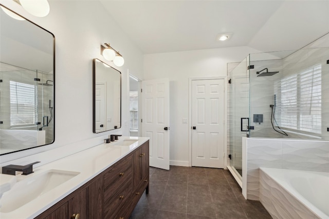 bathroom with a stall shower, a garden tub, a sink, and tile patterned floors