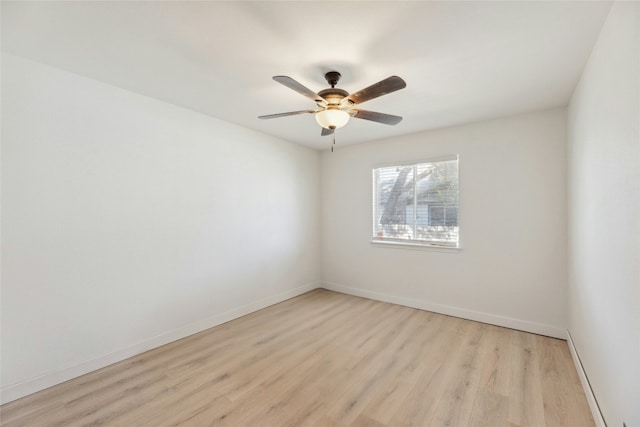 unfurnished room with baseboards, a ceiling fan, and light wood-style floors