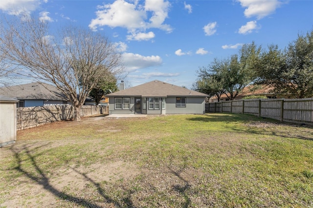 back of house featuring a patio, a lawn, a fenced backyard, and stucco siding