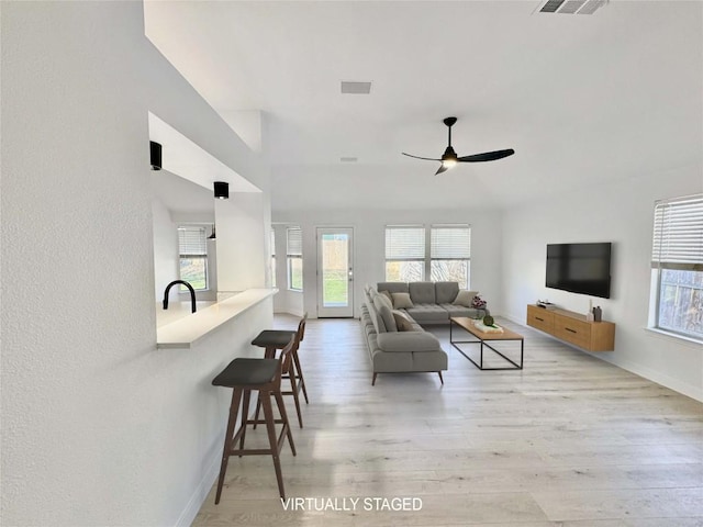 203 Little Lake Rd, Hutto, TX 78634 - living area with plenty of natural light, light wood finished floors, and a ceiling fan