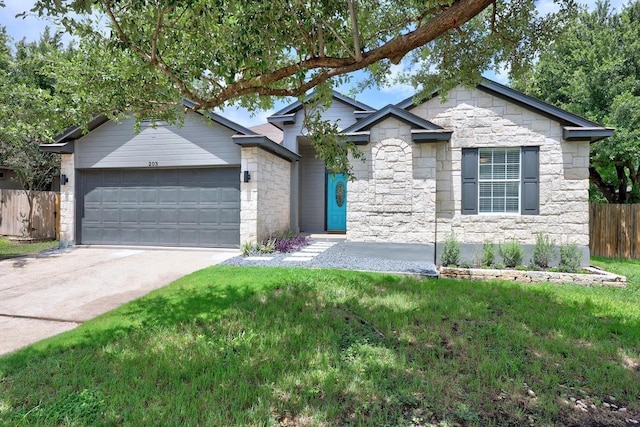203 Little Lake Rd, Hutto, TX 78634 - ranch-style house with stone siding, an attached garage, and concrete driveway