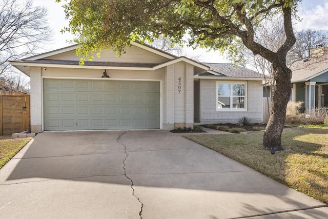 single story home with a garage, roof with shingles, concrete driveway, and brick siding