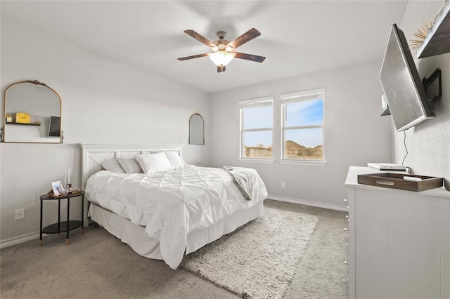 bedroom with ceiling fan, baseboards, and carpet flooring