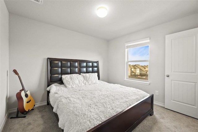 bedroom with baseboards and carpet flooring