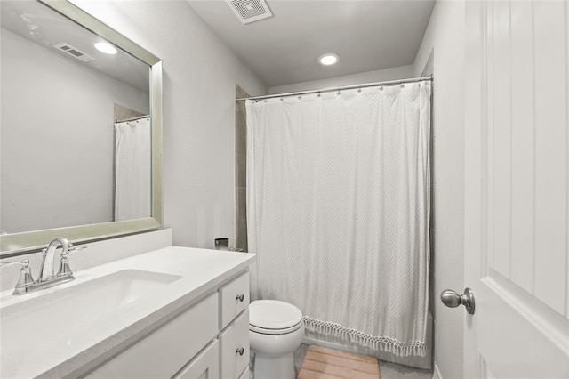 full bathroom featuring toilet, vanity, and visible vents