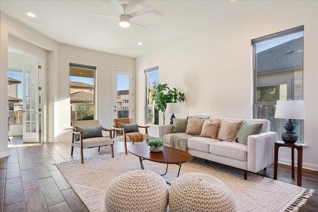 living area featuring a ceiling fan, recessed lighting, dark wood finished floors, and baseboards