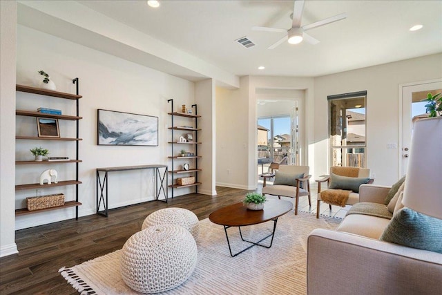 living area with recessed lighting, visible vents, baseboards, and wood finished floors