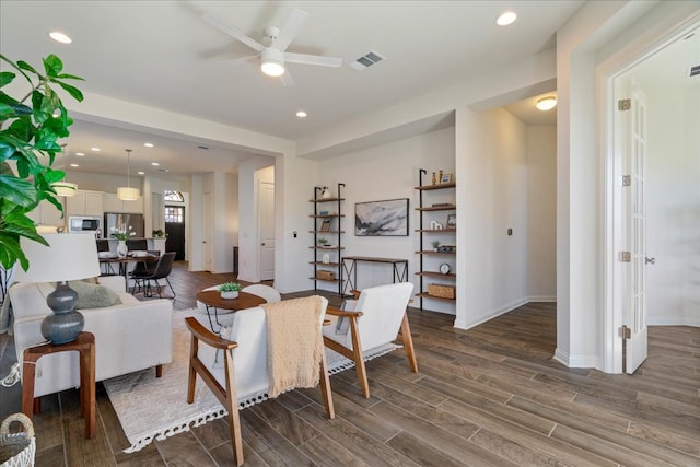 living area featuring wood finish floors, recessed lighting, visible vents, ceiling fan, and baseboards