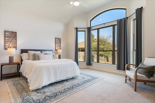 bedroom with lofted ceiling, ceiling fan, baseboards, and carpet flooring