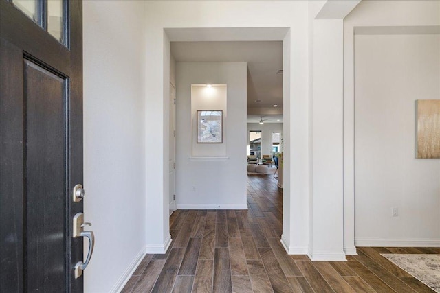 entryway with wood finish floors and baseboards