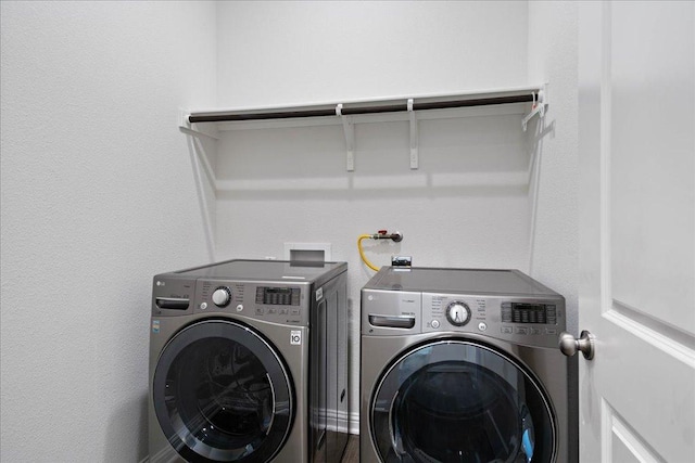 clothes washing area featuring laundry area and washing machine and dryer