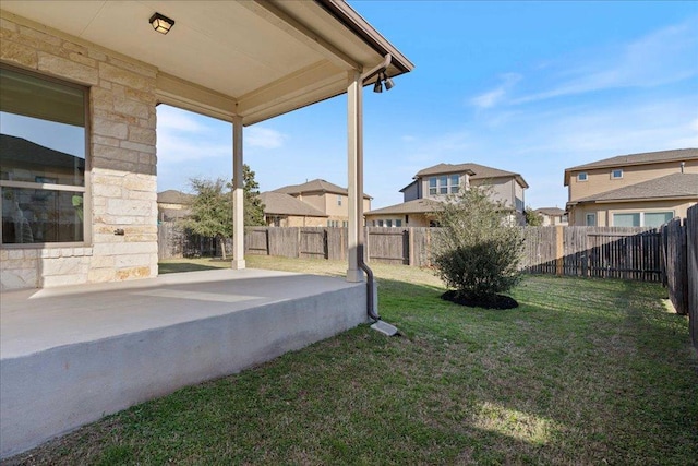 view of yard featuring a residential view, a fenced backyard, and a patio