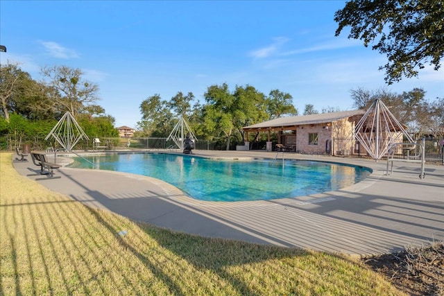 community pool featuring a patio area and fence