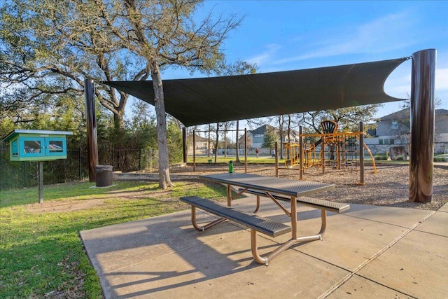 view of property's community with playground community and a lawn