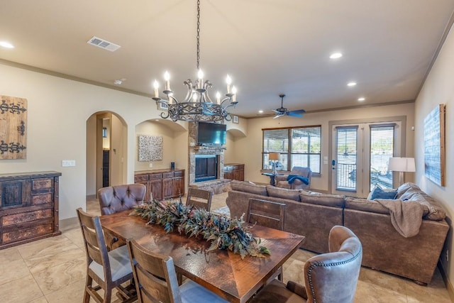 dining space featuring recessed lighting, visible vents, ornamental molding, and a stone fireplace