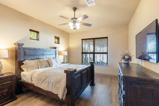 bedroom with visible vents, ceiling fan, baseboards, and wood finished floors