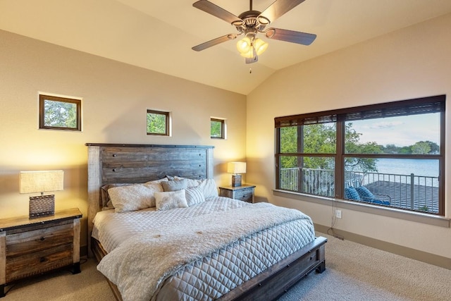 bedroom with lofted ceiling, a water view, baseboards, and carpet flooring