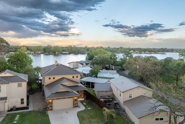 aerial view at dusk with a water view