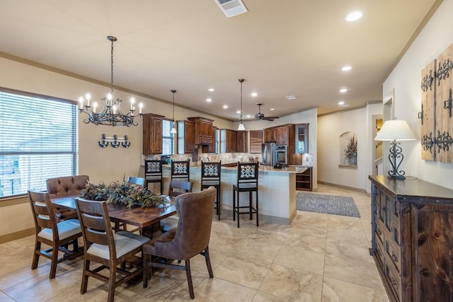 dining space featuring crown molding, recessed lighting, visible vents, baseboards, and ceiling fan with notable chandelier