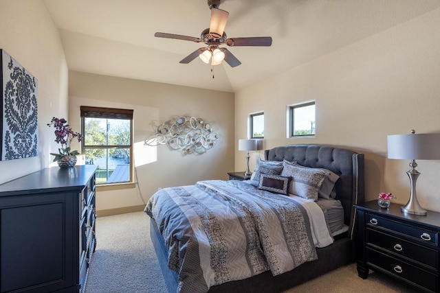 bedroom featuring lofted ceiling, ceiling fan, baseboards, and light colored carpet