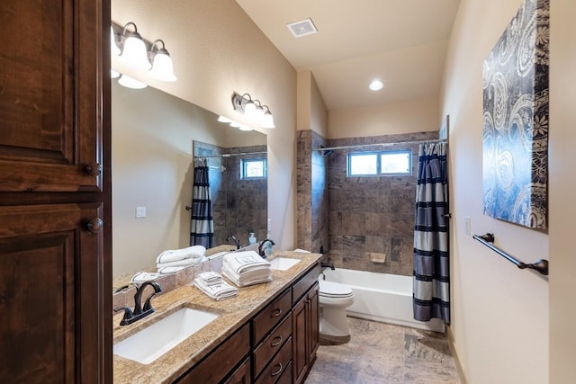 bathroom with double vanity, visible vents, a sink, and shower / bath combo with shower curtain