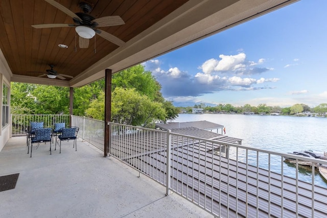 view of patio / terrace with a water view and a ceiling fan