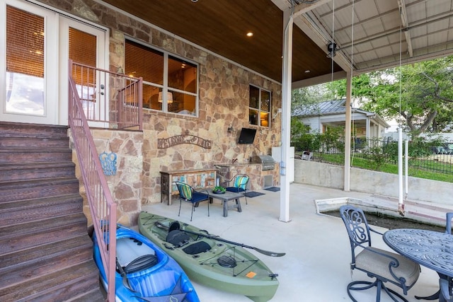 view of patio / terrace featuring area for grilling, a fireplace, and fence