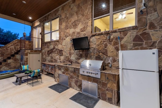 view of patio featuring stairs, an outdoor kitchen, and grilling area