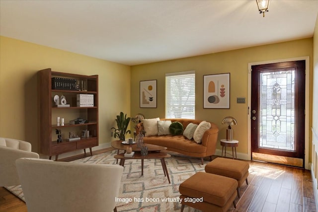 living area featuring baseboards and wood finished floors