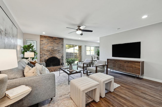 living room with a fireplace, recessed lighting, ceiling fan, wood finished floors, and baseboards