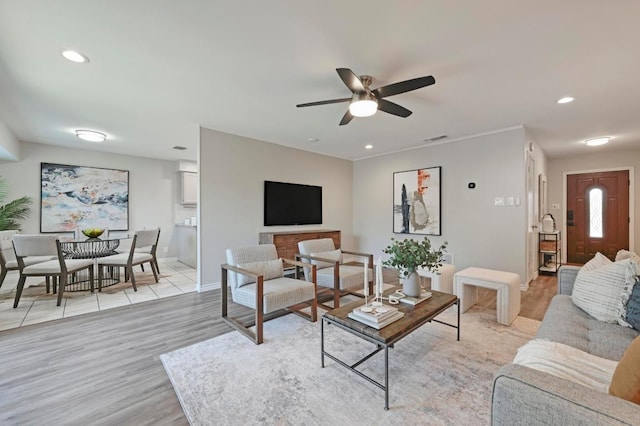 living room featuring visible vents, ceiling fan, light wood-style flooring, and recessed lighting