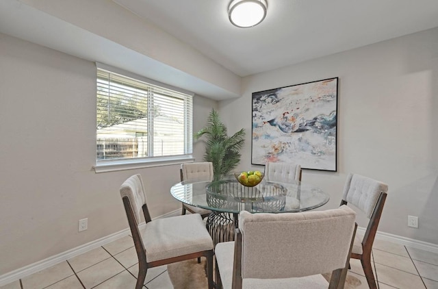 dining room featuring baseboards and light tile patterned flooring