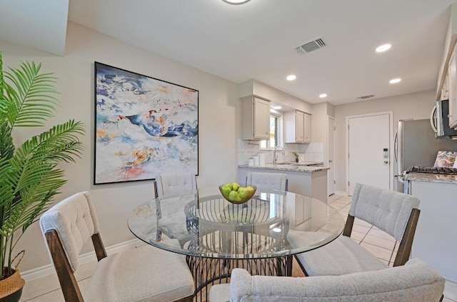 dining area featuring light tile patterned floors, recessed lighting, visible vents, and baseboards