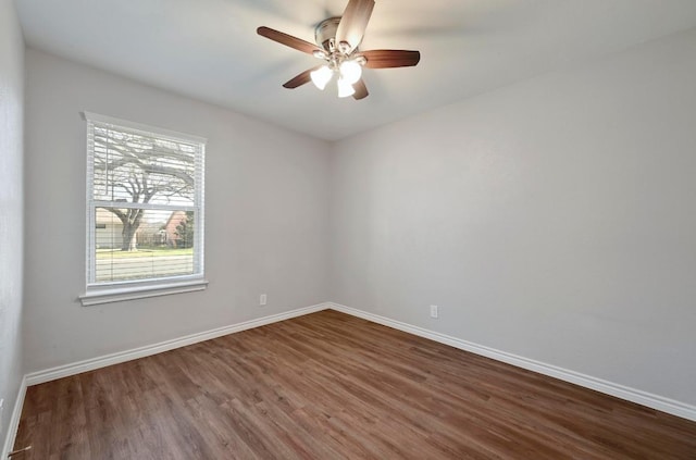 unfurnished room with ceiling fan, baseboards, and wood finished floors