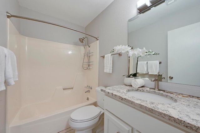 bathroom with toilet, vanity, and washtub / shower combination