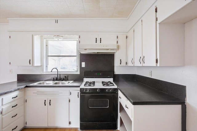 kitchen with under cabinet range hood, a sink, white cabinetry, gas stove, and dark countertops