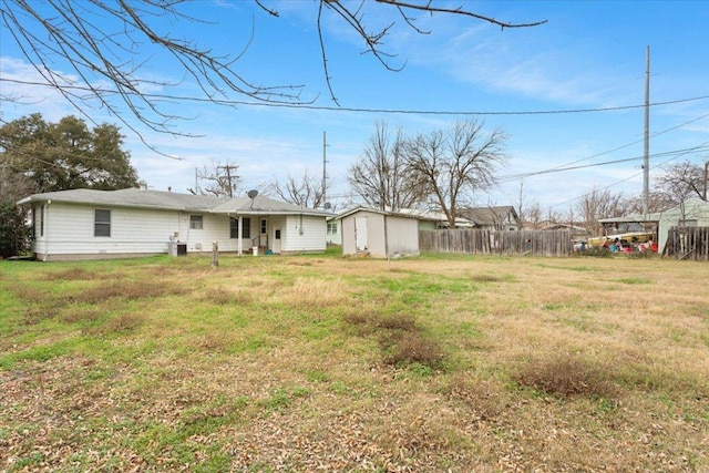 view of yard featuring fence and an outdoor structure