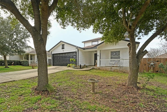 traditional-style house featuring concrete driveway, an attached garage, fence, a porch, and brick siding