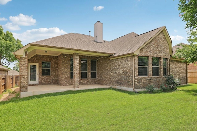 2629 Estefania Ln, Round Rock, TX 78665 - rear view of house with a chimney, a patio, brick siding, and a shingled roof